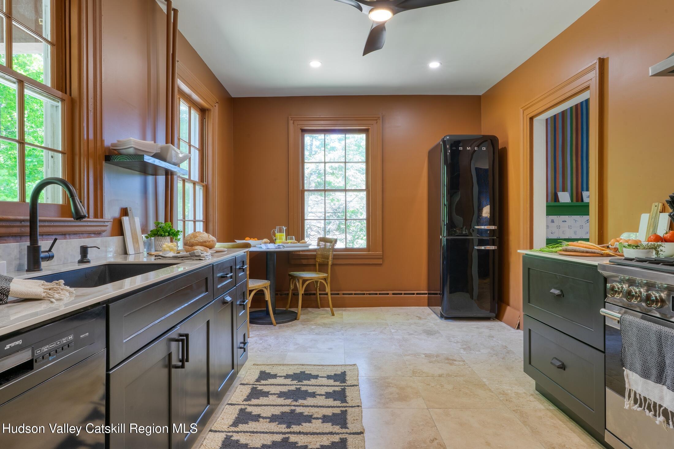 3714 Main Street Stone Ridge, NY 12484 - Photo 18 of 31 a kitchen with kitchen island granite countertop a sink stove and refrigerator