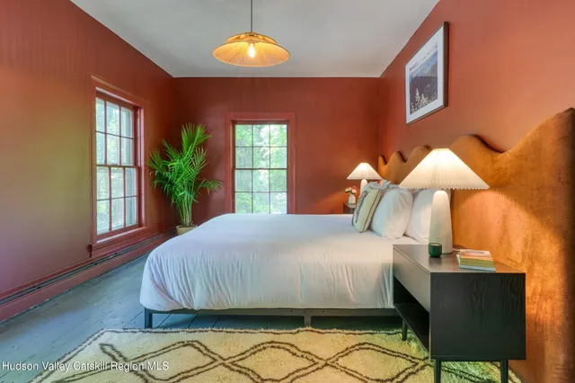 a bedroom with a bed and a potted plant