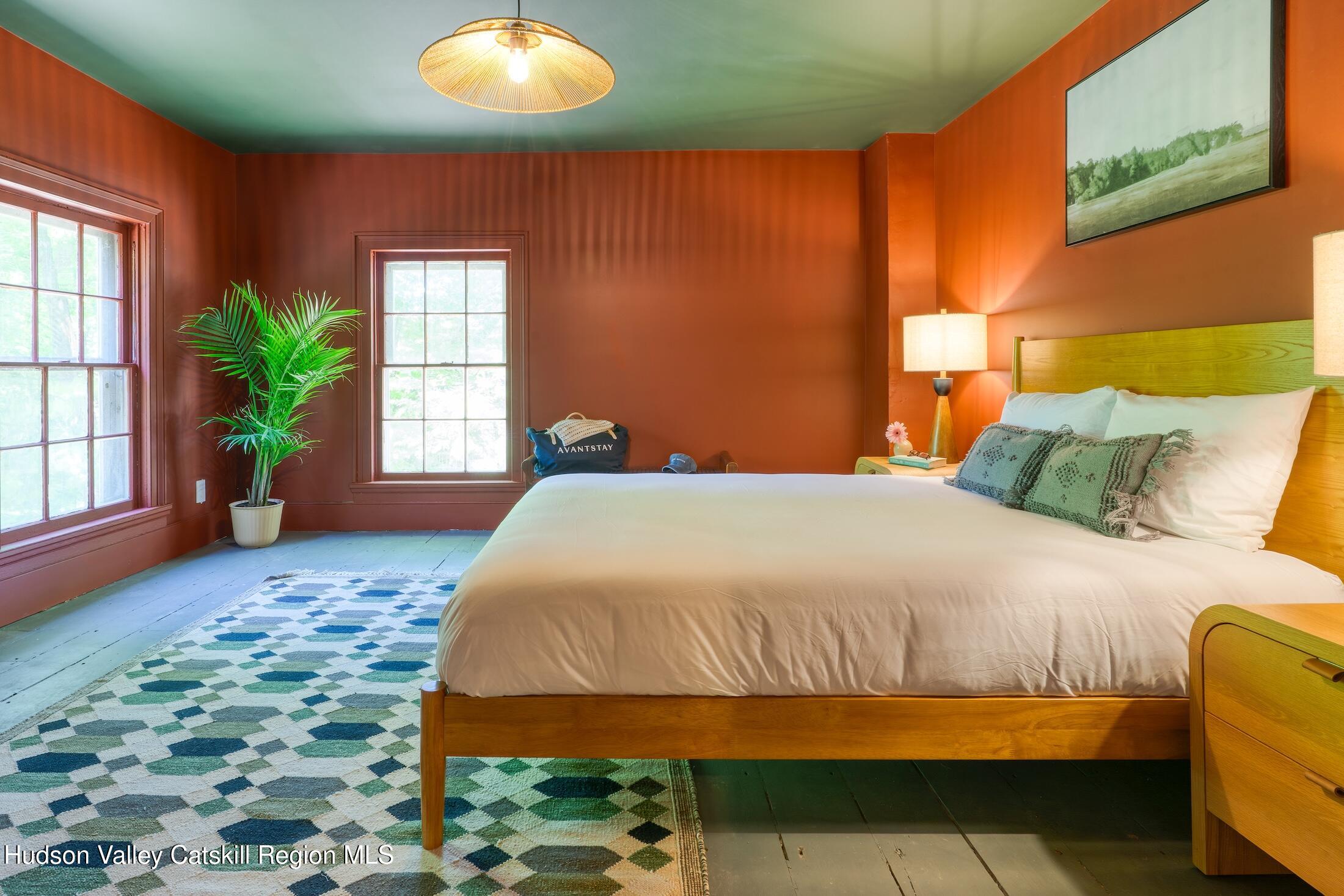 3714 Main Street Stone Ridge, NY 12484 - Photo 22 of 31 a bedroom with a bed and a potted plant