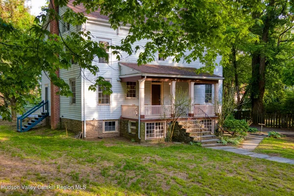 a view of a house with a yard porch and sitting area