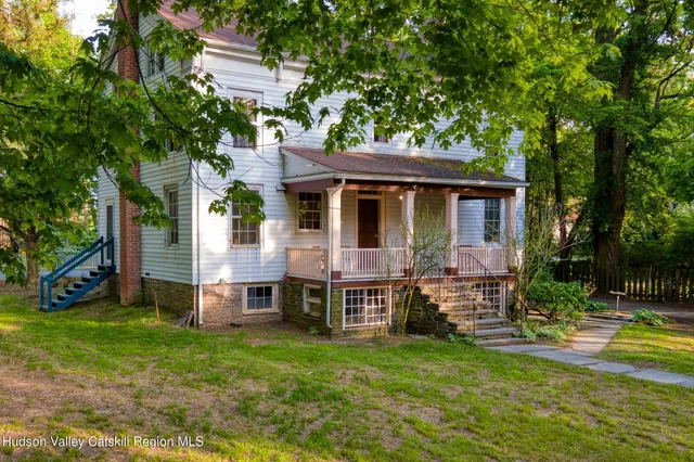 a view of a house with a yard porch and sitting area