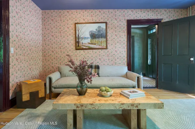 a view of living room filled with furniture and a large window