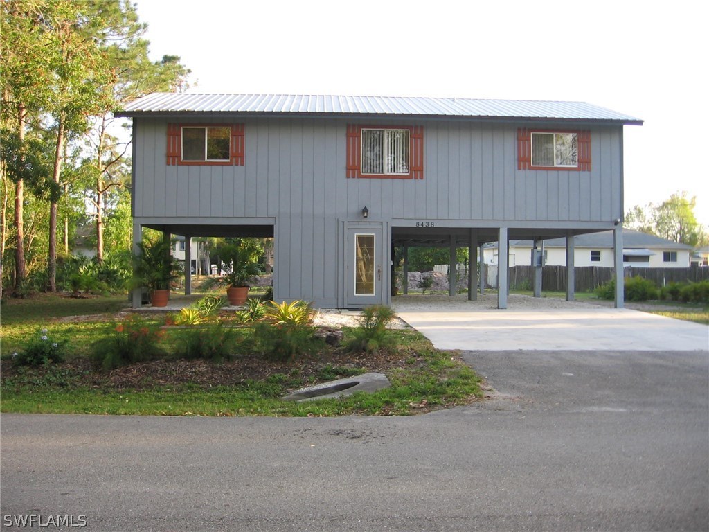 8438 Robin Road Fort Myers, FL 33967 - Photo 3 of 24 a front view of a house with garden