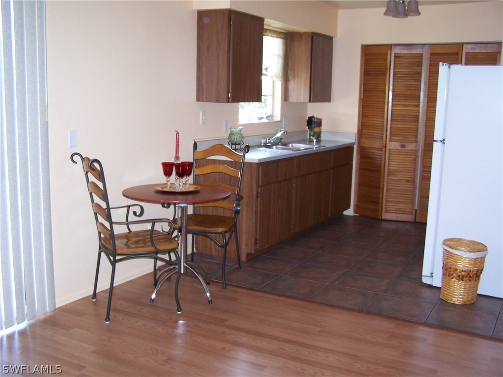 8438 Robin Road Fort Myers, FL 33967 - Photo 8 of 24 a dining room with furniture and wooden floor