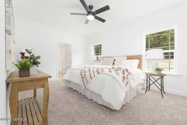 a spacious bedroom with a bed and a table