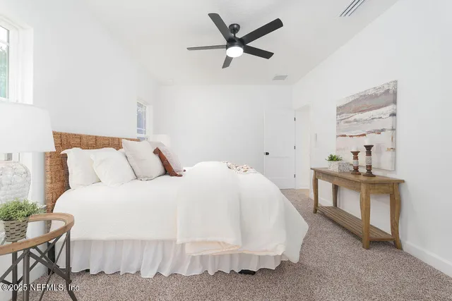 a bed room with bed and a chair