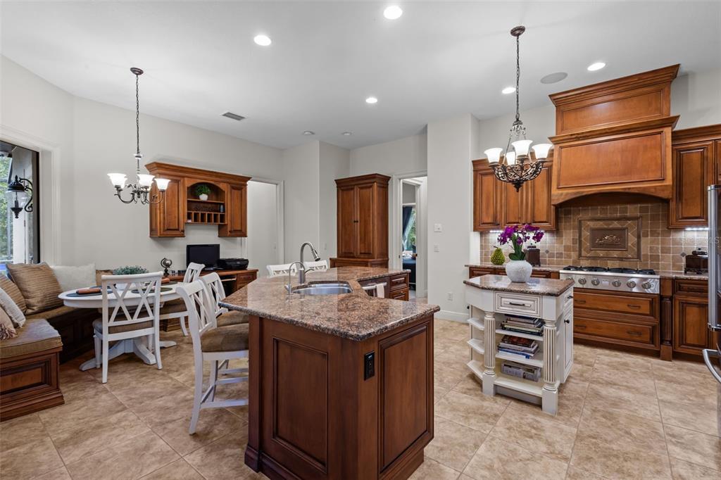 10826 Alico Pass New Port Richey, FL 34655 - Photo 11 of 51 a kitchen that has a lot of cabinets in it and stainless steel appliances