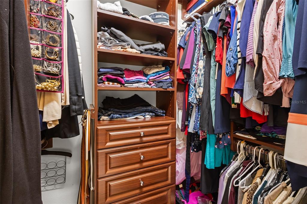 10826 Alico Pass New Port Richey, FL 34655 - Photo 22 of 51 a view of walk in closet with clothes and shoes