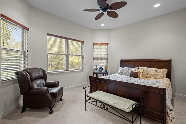 a bedroom with a bed couch and window