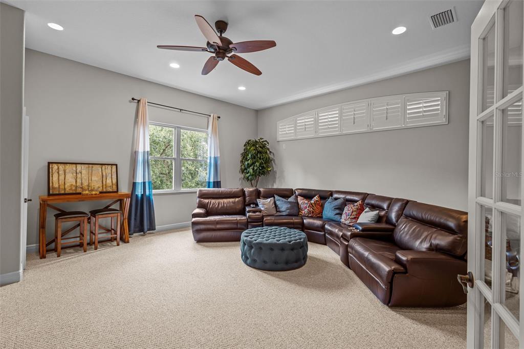 10826 Alico Pass New Port Richey, FL 34655 - Photo 36 of 51 a living room with furniture a ceiling fan and a window