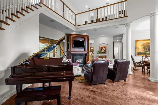 a living room with furniture a flat screen tv and paintings on the wall