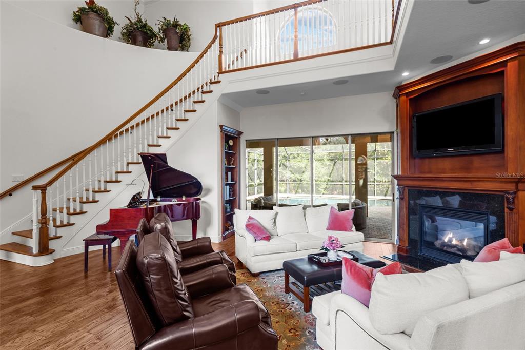 10826 Alico Pass New Port Richey, FL 34655 - Photo 9 of 51 a living room with furniture a flat screen tv and a fireplace