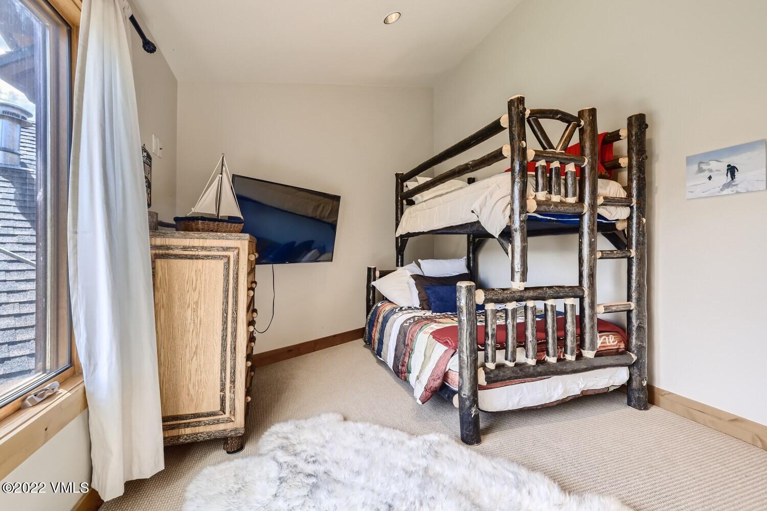 290 Amherst Road Gypsum, CO 81637 - Photo 17 of 32 a bedroom with furniture and white walls