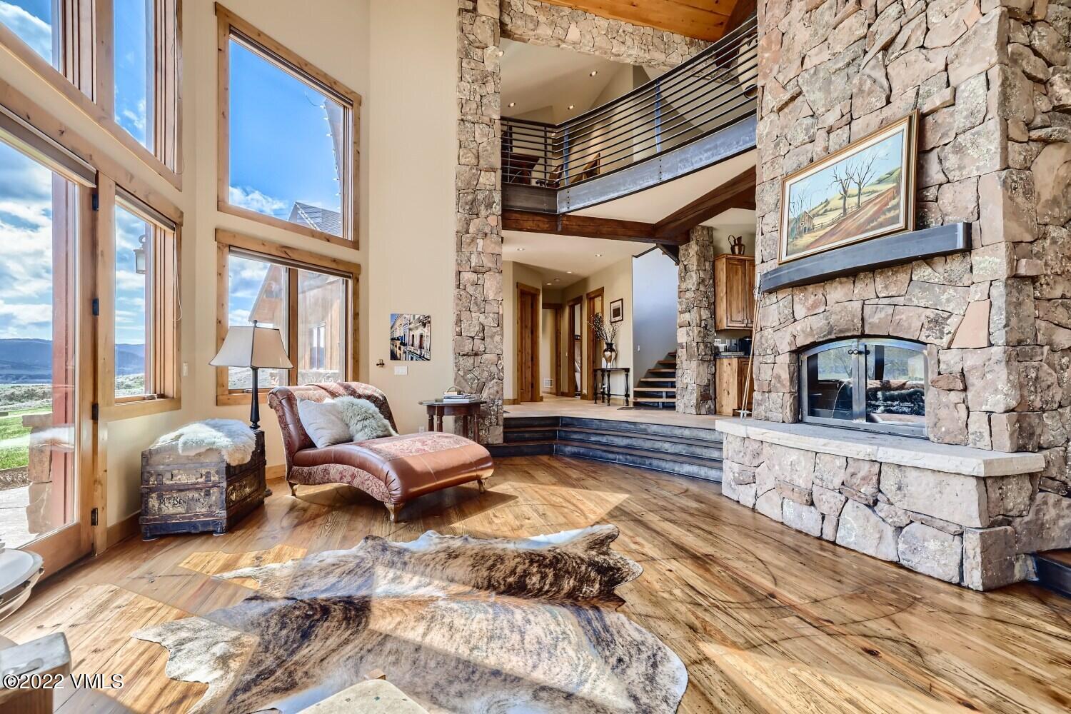 290 Amherst Road Gypsum, CO 81637 - Photo 2 of 32 a bedroom with furniture and a fireplace