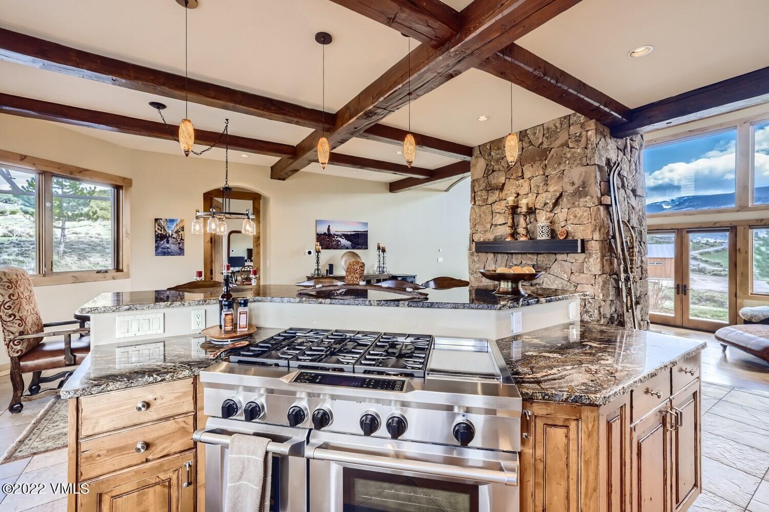290 Amherst Road Gypsum, CO 81637 - Photo 7 of 32 a kitchen with a stove and a wooden cabinets