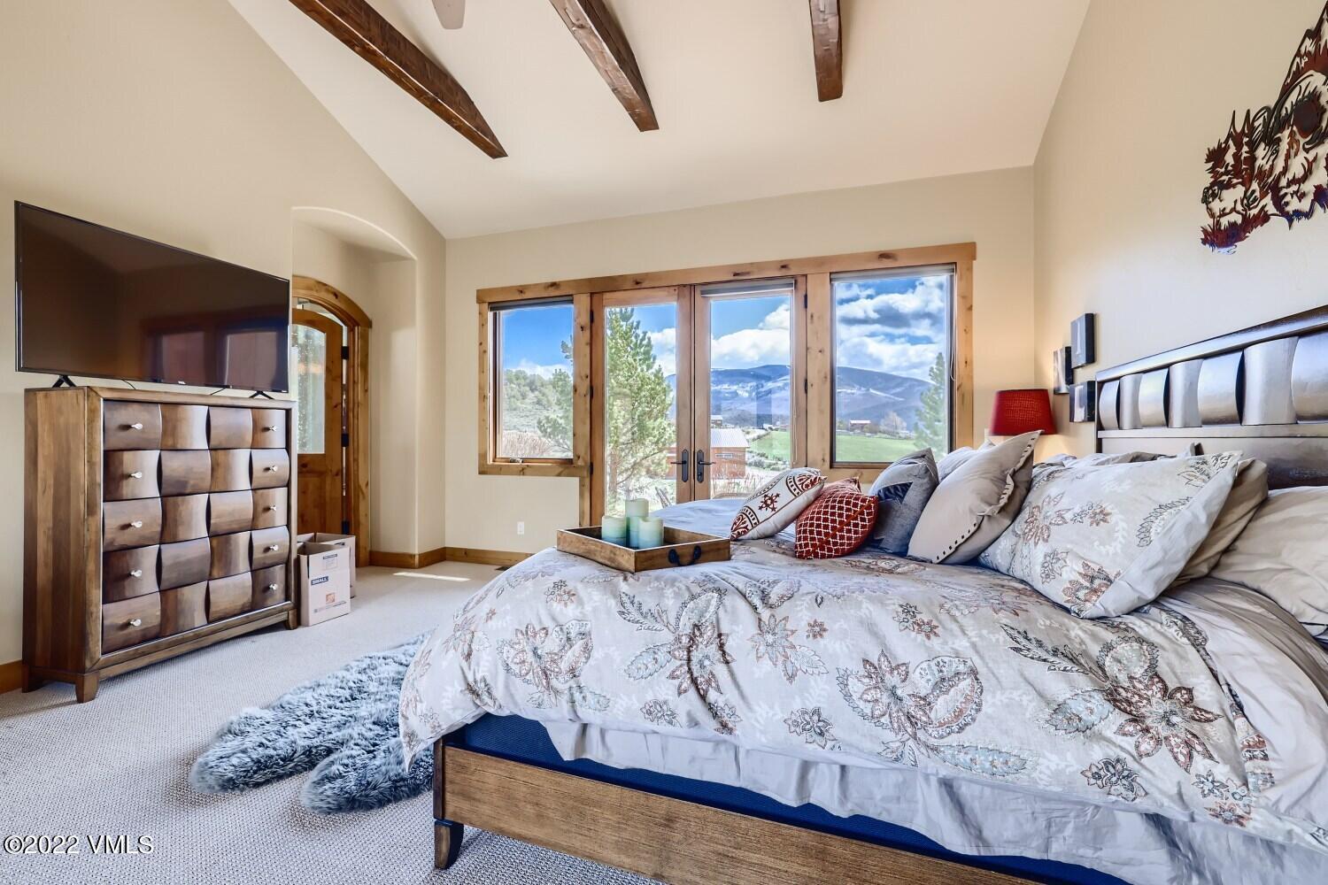 290 Amherst Road Gypsum, CO 81637 - Photo 8 of 32 a bedroom with a large bed and a window