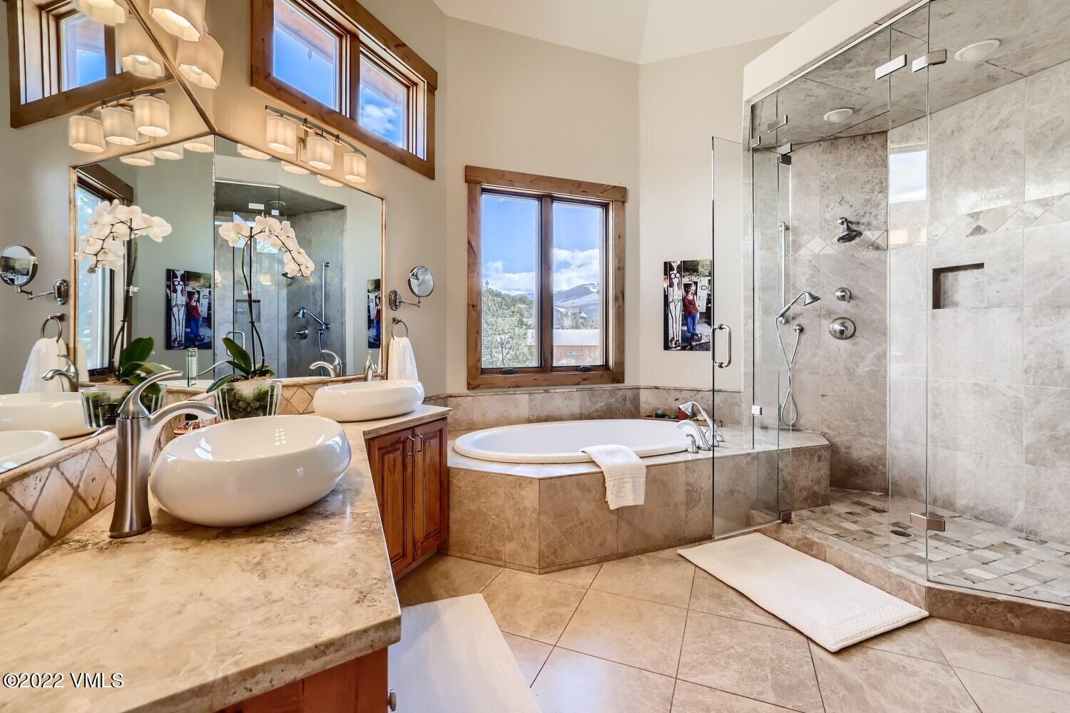 290 Amherst Road Gypsum, CO 81637 - Photo 10 of 32 a large spacious bathroom with a granite countertop tub sink and mirror
