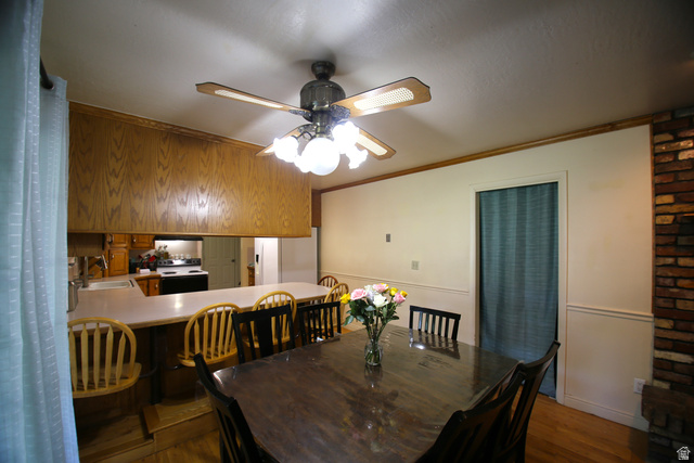 1612 East 450 South Springville, UT 84663 - Photo 16 of 48 Dining area featuring a wood-finish dining table and a ceiling fan with integrated lighting