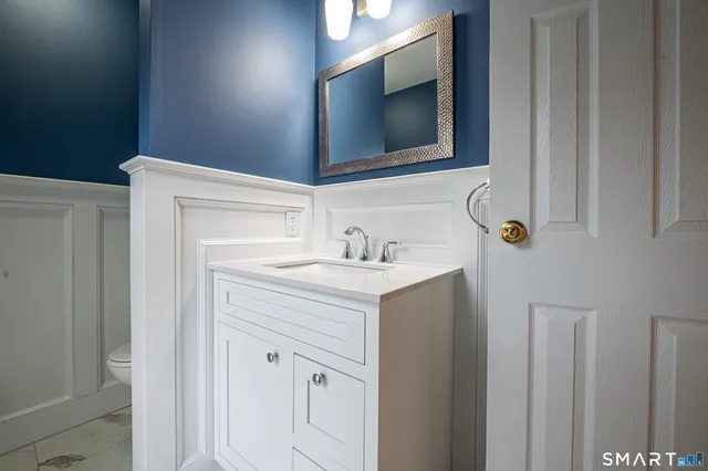 a bathroom with a sink vanity and mirror