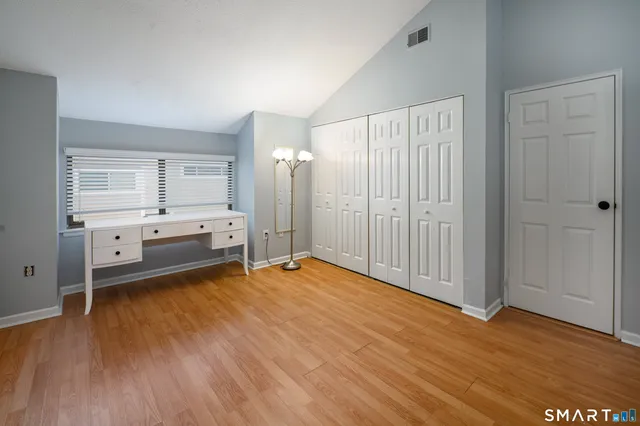 a view of a kitchen with wooden floor and window