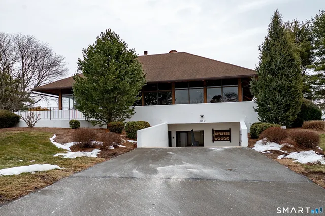 a view of house with outdoor space and parking