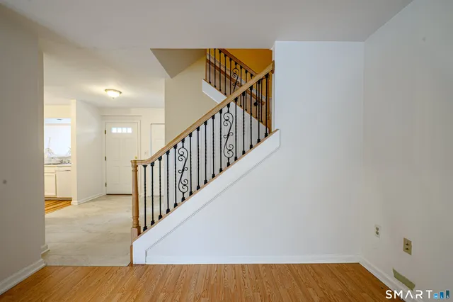 a view of entryway and hall with wooden floor