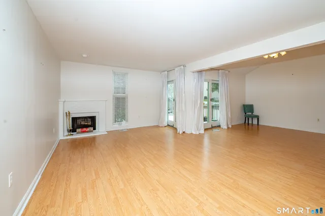 a view of empty room with a fireplace
