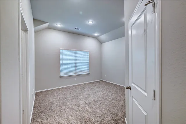 an empty room with closet and a bathroom
