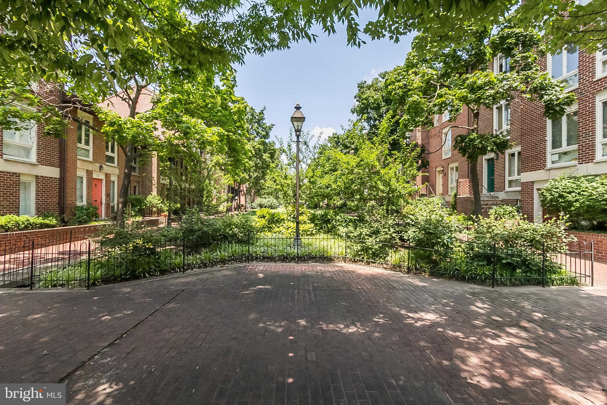 630 South Hanover Street Baltimore, MD 21230 - Photo 52 of 55 a view of a street with potted plants and large trees