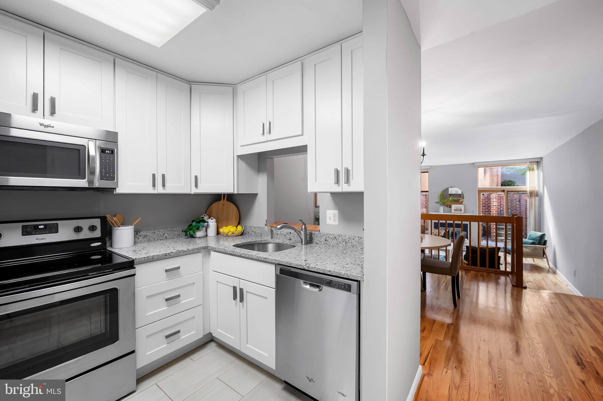 630 South Hanover Street Baltimore, MD 21230 - Photo 8 of 55 a kitchen with a sink white cabinets and stainless steel appliances