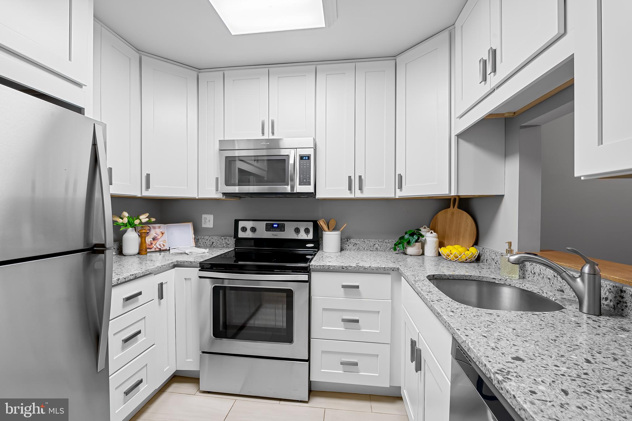 630 South Hanover Street Baltimore, MD 21230 - Photo 9 of 55 a kitchen with stainless steel appliances granite countertop a sink stove and refrigerator