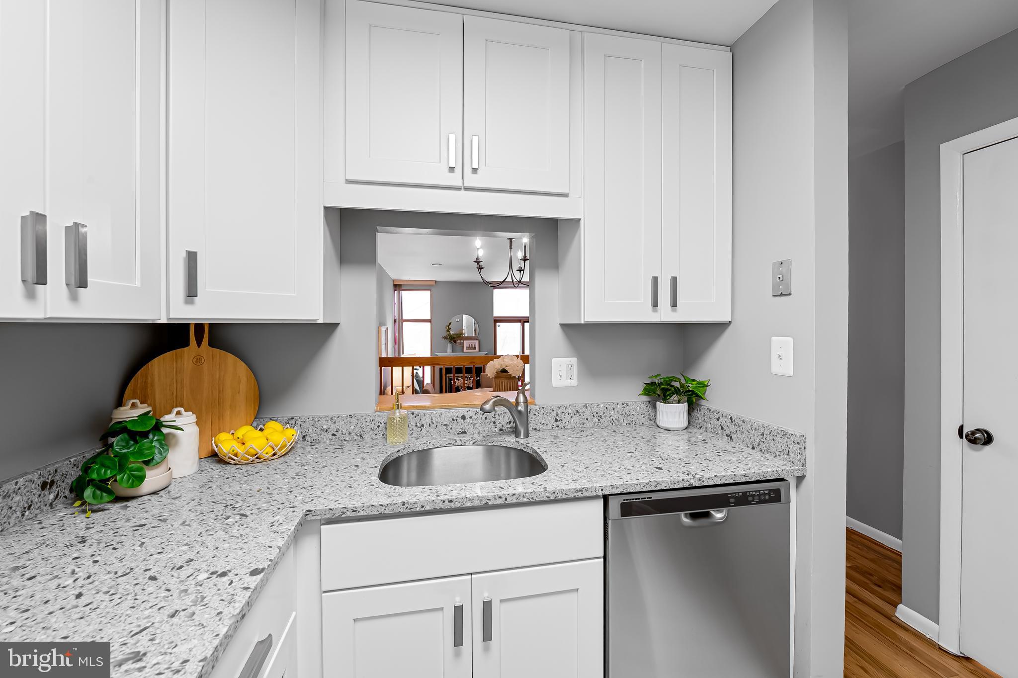 630 South Hanover Street Baltimore, MD 21230 - Photo 10 of 55 a kitchen with white cabinets and a sink