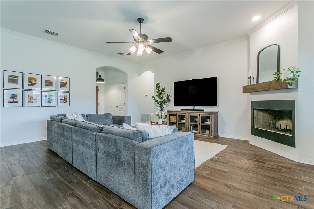 8304 Split Trl Cove Temple, TX 76502 - Photo 3 of 28 a living room with furniture a flat screen tv and a fireplace