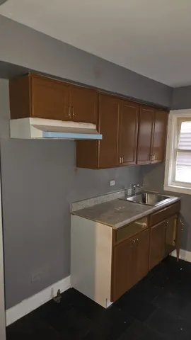 a kitchen with a sink and cabinets