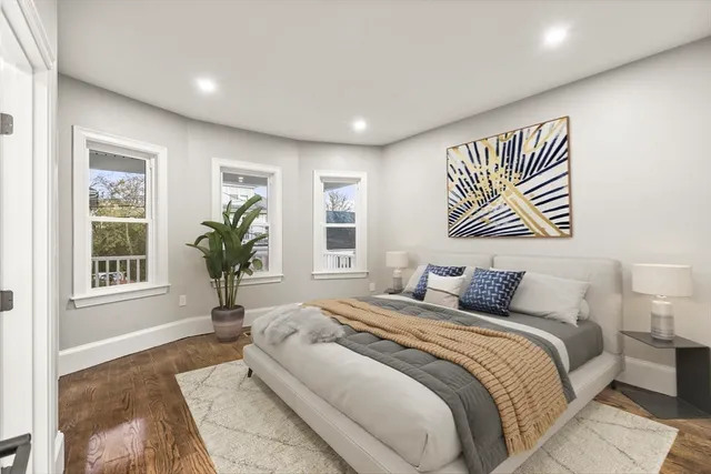 a bedroom with a large bed and a window