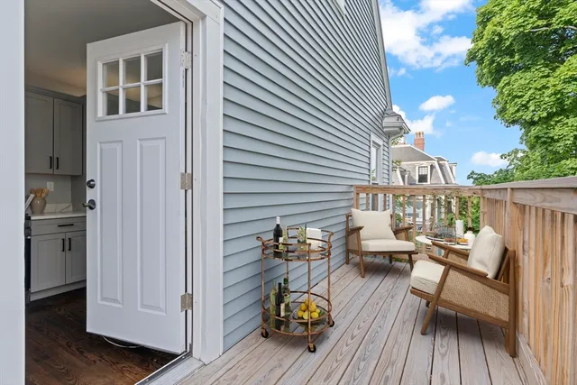 a view of a deck with chairs and wooden floor