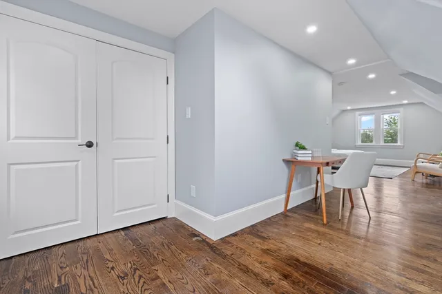a view of a room with wooden floor and windows