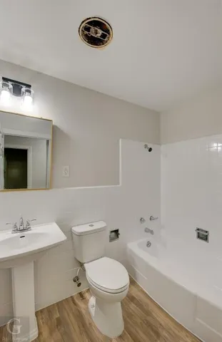 a bathroom with a sink a toilet and a bathtub