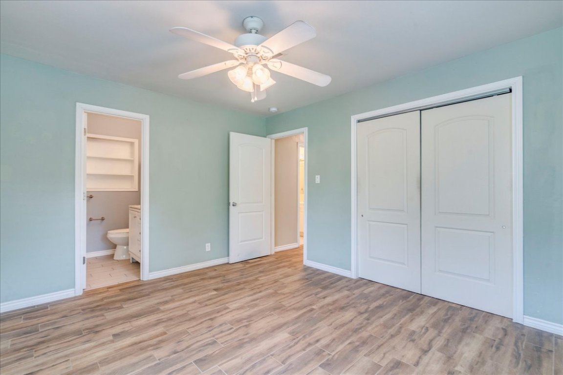 4712 Frontier Trail Austin, TX 78745 - Photo 17 of 32 wooden floor in an empty room with a window
