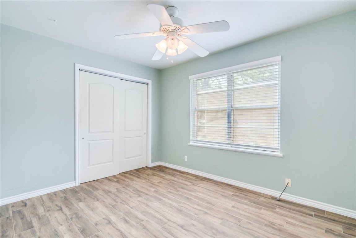 4712 Frontier Trail Austin, TX 78745 - Photo 21 of 32 a view of an empty room with window and wooden floor