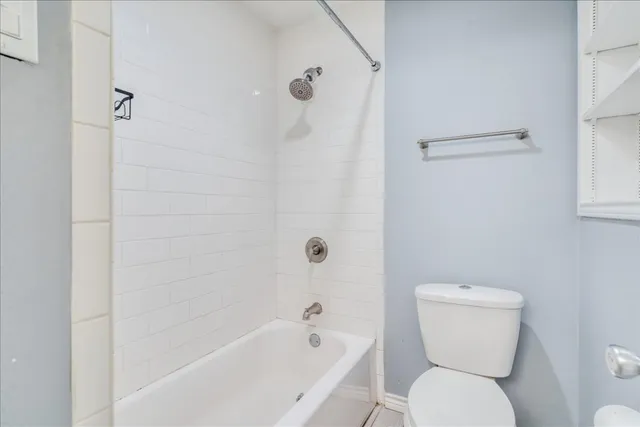 a bathroom with a toilet and a bathtub