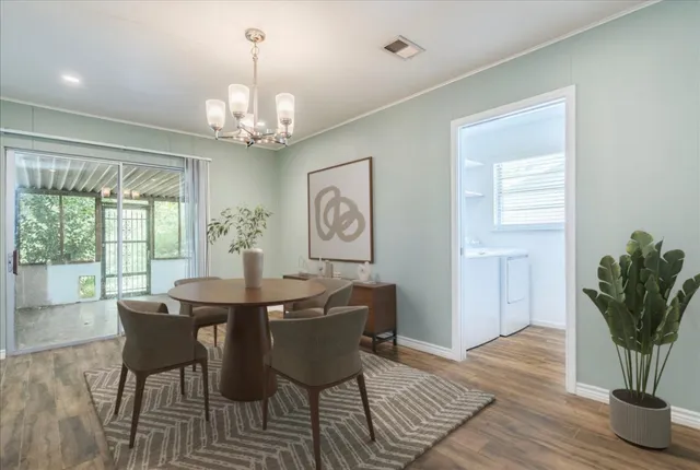 a view of a dining room with furniture window and wooden floor