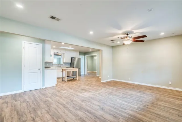 a view of a kitchen with a sink and cabinets