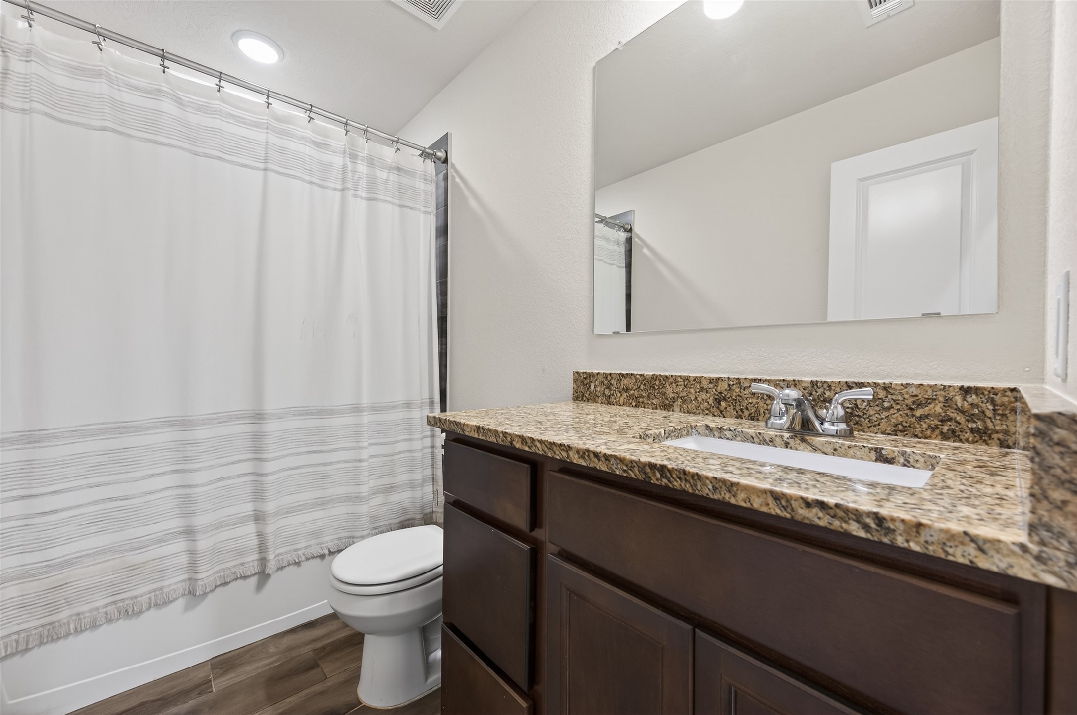 917 Farm Path Brenham, TX 77833 - Photo 30 of 43 a bathroom with a granite countertop sink toilet and shower