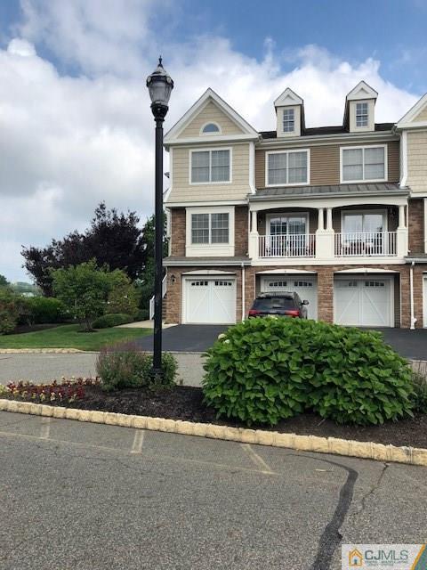 4 Raritan Reach Road, Unit 1002 South Amboy, NJ 08879 - Photo 1 of 19 a front view of a house with a yard and potted plants