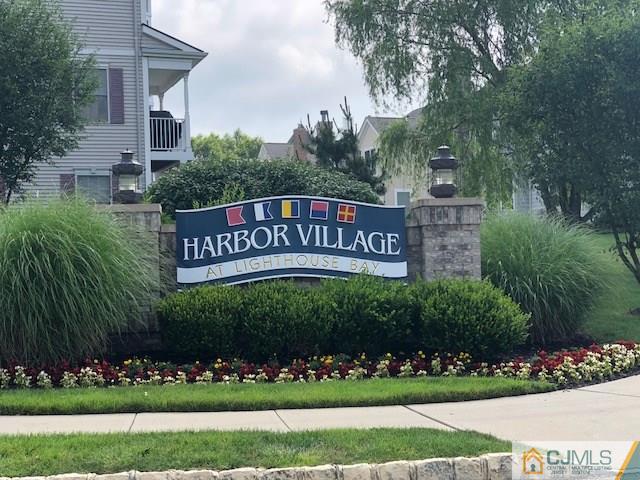 4 Raritan Reach Road, Unit 1002 South Amboy, NJ 08879 - Photo 2 of 19 a view of a sign board with flower garden