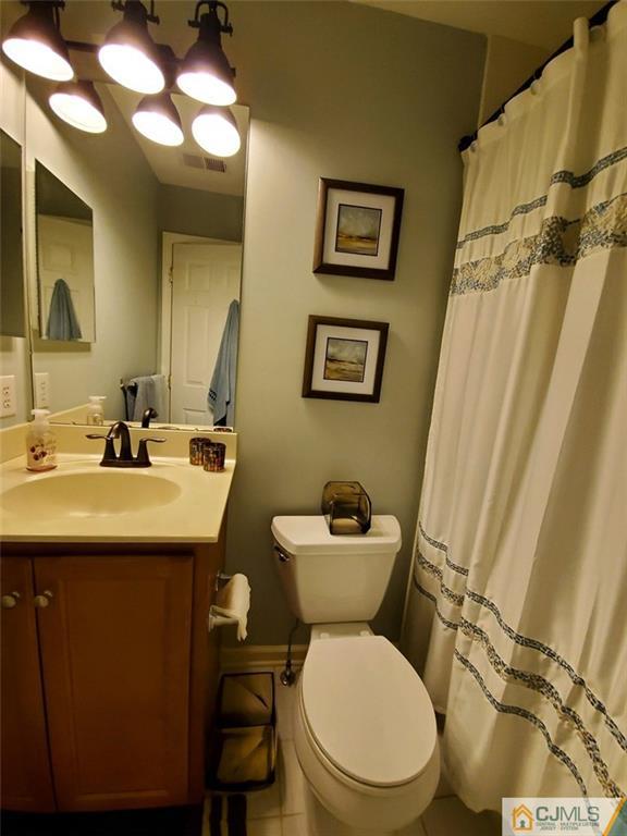4 Raritan Reach Road, Unit 1002 South Amboy, NJ 08879 - Photo 12 of 19 a bathroom with a toilet sink and mirror