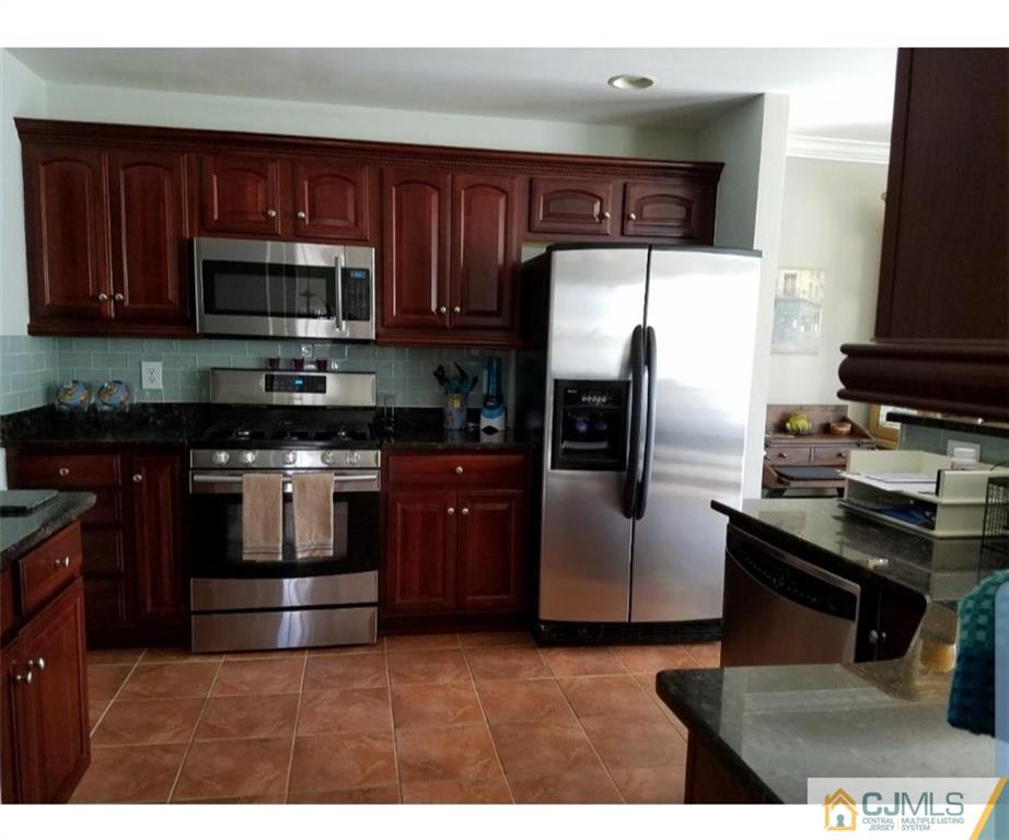 4 Raritan Reach Road, Unit 1002 South Amboy, NJ 08879 - Photo 3 of 19 a kitchen with stainless steel appliances granite countertop a stove a refrigerator and a microwave