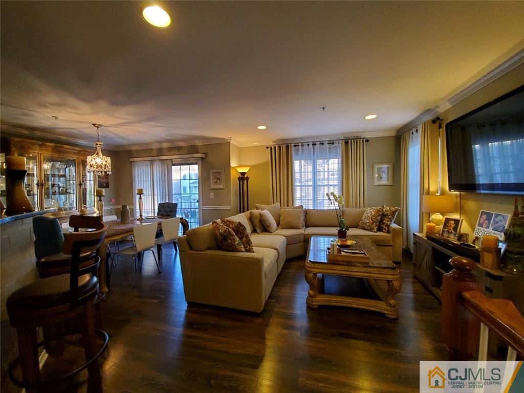4 Raritan Reach Road, Unit 1002 South Amboy, NJ 08879 - Photo 4 of 19 a living room with furniture and a flat screen tv