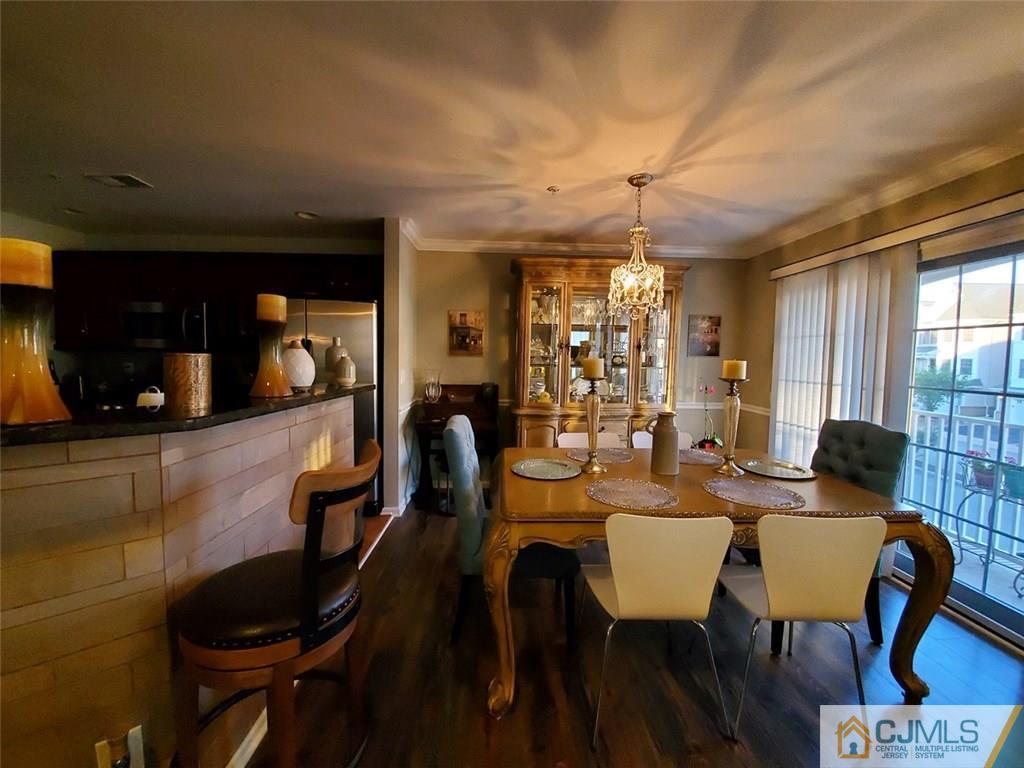 4 Raritan Reach Road, Unit 1002 South Amboy, NJ 08879 - Photo 5 of 19 a view of a dining room with furniture and wooden floor